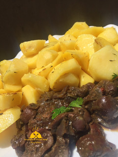 A picture of Potatoes and kidney sauce.