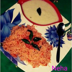 A picture of Tomato rice with bottle gourd raita.