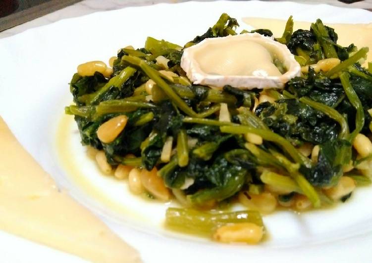 Espinacas con queso curado, cabra y piñones