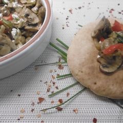 A picture of Roasted mushrooms marinated in white wine topped feta cheese.