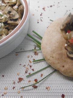 A picture of Roasted mushrooms marinated in white wine topped feta cheese.