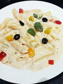 A picture of Penne Pasta in white sauce.