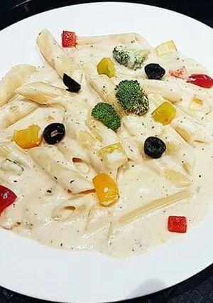 A picture of Penne Pasta in white sauce.