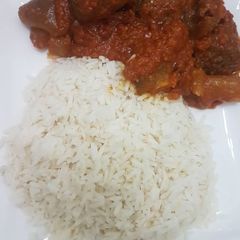 A picture of Beef stew and rice.