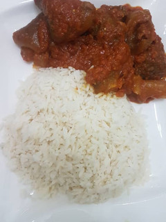 A picture of Beef stew and rice.