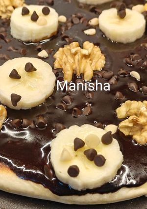 A picture of Chocolate walnut banana pizza (loaded with chocolate ganache) kids recipe for christmas party.