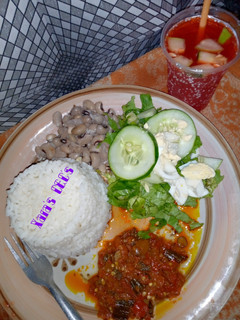 A picture of 9ja white rice, beans and locust beans sauce (garnished).