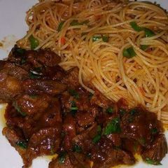 A picture of Fried noodles with wet fried beef.