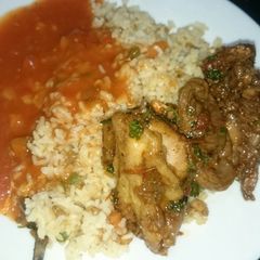 A picture of Veg rice and fried chicken with sauce.