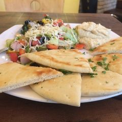 A picture of Mediterranean salad with pita bread.