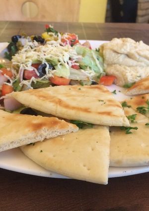 A picture of Mediterranean salad with pita bread.