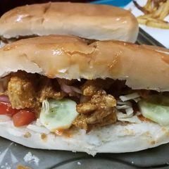 A picture of Subway style sandwiches with chipotle sauce.