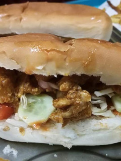 A picture of Subway style sandwiches with chipotle sauce.