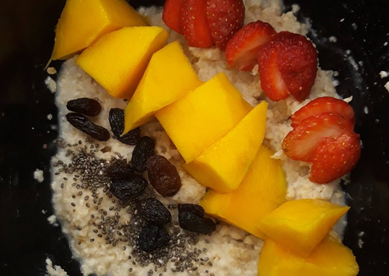 Breakfast (oatmeal with chia seed, raisin, yogurt and sliced fruit)