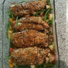 A picture of Oven roasted chicken with veggies.