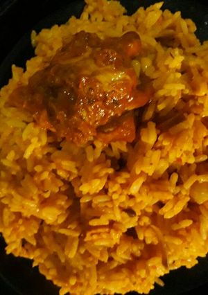 A picture of Jollof rice and Turkey.