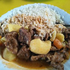 A picture of Rice with beef stew.