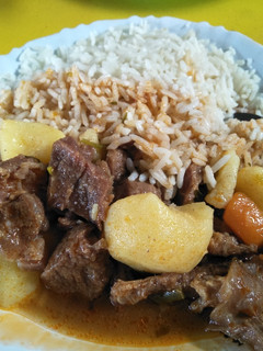 A picture of Rice with beef stew.