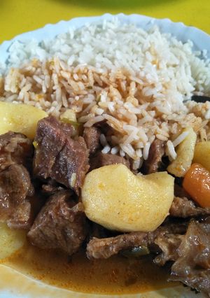A picture of Rice with beef stew.