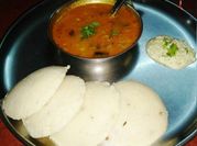 A picture of tomato and onion sambar