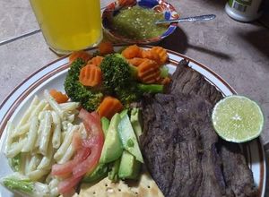 Una foto de Milanesas doradas en su propio jugo y ensalada de plumilla
