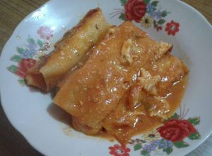 Una foto de Canelones con queso y pollo