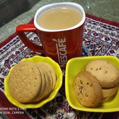 A picture of Ginger Tea with biscuit's.