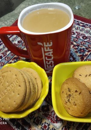 A picture of Ginger Tea with biscuit's.