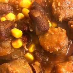 A picture of Beef sausages in tomato sauce.