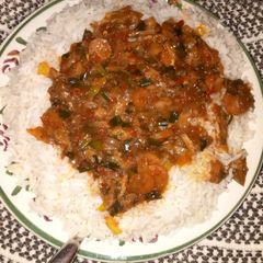 A picture of White rice wth vegetable soup.