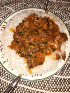 A picture of White rice wth vegetable soup.