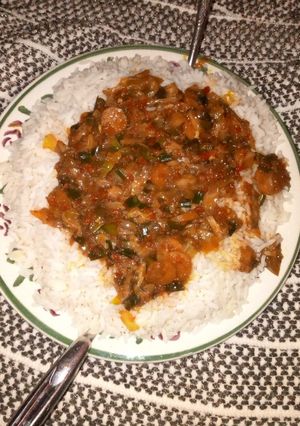 A picture of White rice wth vegetable soup.