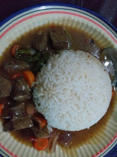 A picture of White rice with kidney sauce.