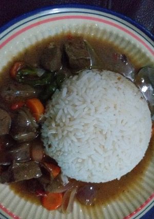 A picture of White rice with kidney sauce.