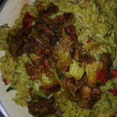 A picture of Curry jallof rice with meat pepper.