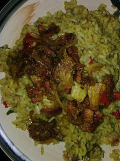 A picture of Curry jallof rice with meat pepper.