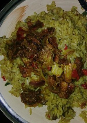 A picture of Curry jallof rice with meat pepper.
