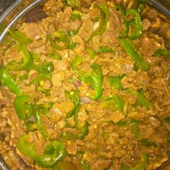 A picture of Shredded beef and green pepper.