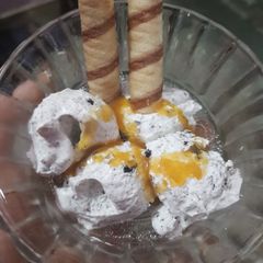 A picture of Oreo vanilla ice cream with caramel sauce.