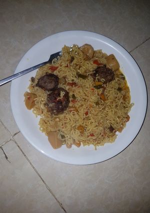 A picture of Noodles with veggies and minced meat balls.