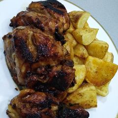 A picture of Glazed chicken and potatoes.