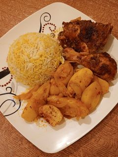 A picture of Baked Chicken Thighs with Potatoes and Onions.