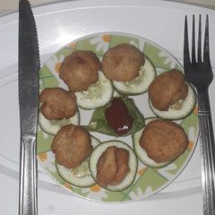 A picture of Bread balls with ketchup.