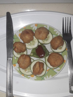 A picture of Bread balls with ketchup.