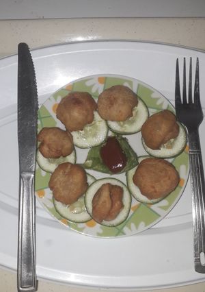 A picture of Bread balls with ketchup.