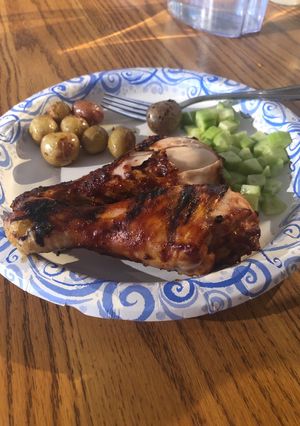 A picture of Bbq chicken legs and roasted potatoes.