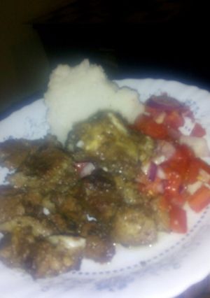 A picture of Fried beef with kachumbari and ugali.