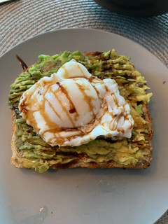 A picture of Avocado 🥑 + Poached Egg 🥚 Sourdough Toast.
