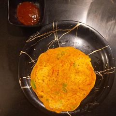 A picture of Sattu oats and veggies chilla.