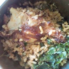A picture of Jallof rice and pumpkin leaf.